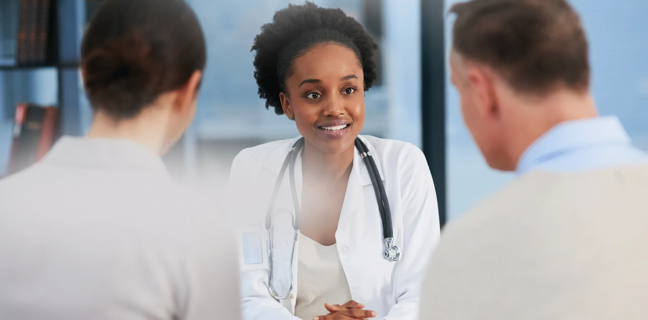 A wound care clinician speaking with patients during a consultation