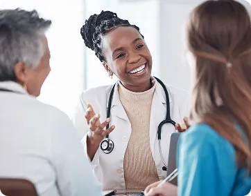 Dr. Akinade in conversation with two healthcare colleagues